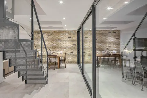 Rose Brentwood Four Storey Refurbishment Contemporary Basement Extension Stainless Steel staircase bifold doors Kitchen Diner