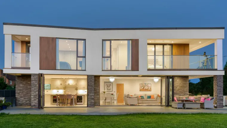 1.HERO North Tye Swanley New Build Contemporary Home corner rear view grey stone cladding timber cladding white render open plan family room kitchen island diner bifold doors