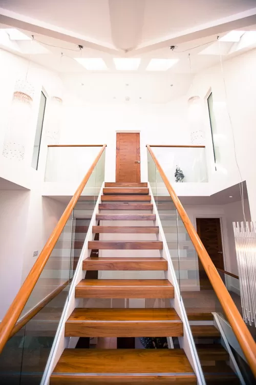 Piran Hutton Shenfield Essex Major Contemporary Extension Refurbishment Walnut frameless glass balustrades stairway