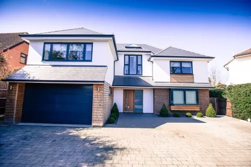 Piran Hutton Shenfield Essex Major Contemporary Extension Refurbishment open plan bifold doors single garage large front facing windows white render grey zinc timber
