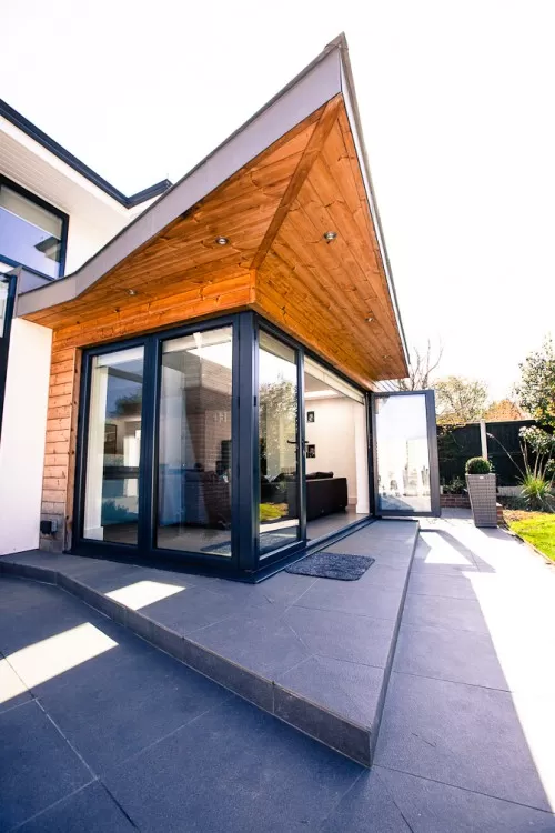 Piran Hutton Shenfield Essex Major Contemporary Extension Refurbishment white render grey zinc timber cladding Walnut frameless glass balustrades 