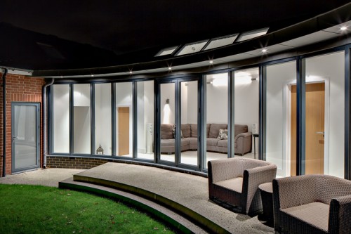 York Curve Shenfield Essex Contemporary Link Extension Zinc Bifold doors Night view Roof windows