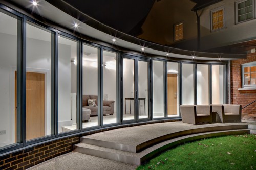 York Curve Shenfield Essex Contemporary Link Extension Zinc Bifold doors Night view zinc roof