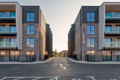 Moreton bay apartments romford open plan living sustainability eco friendly award winning modern car park driveway view dusk saw tooth windows balcony windows zink contemporary architectecture